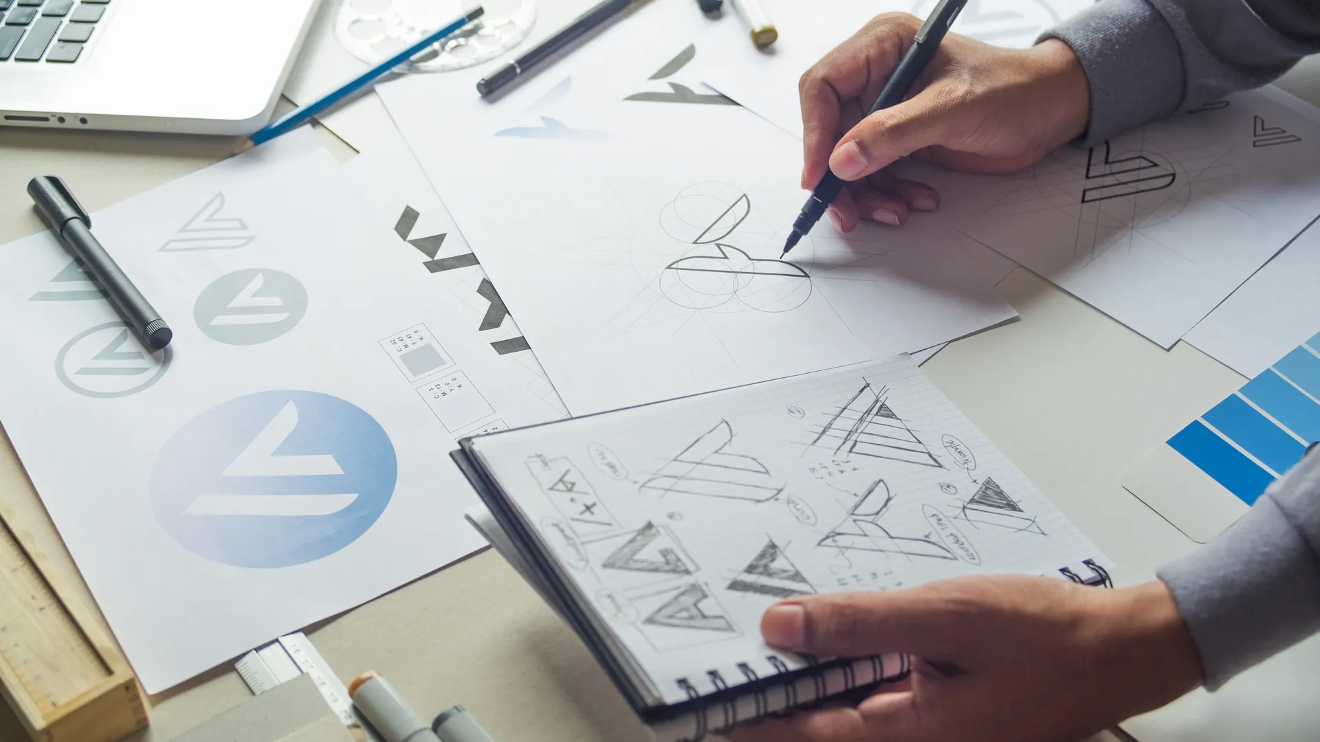 Visual Branding | Home Logo sketches and brand marks on a designer's desk